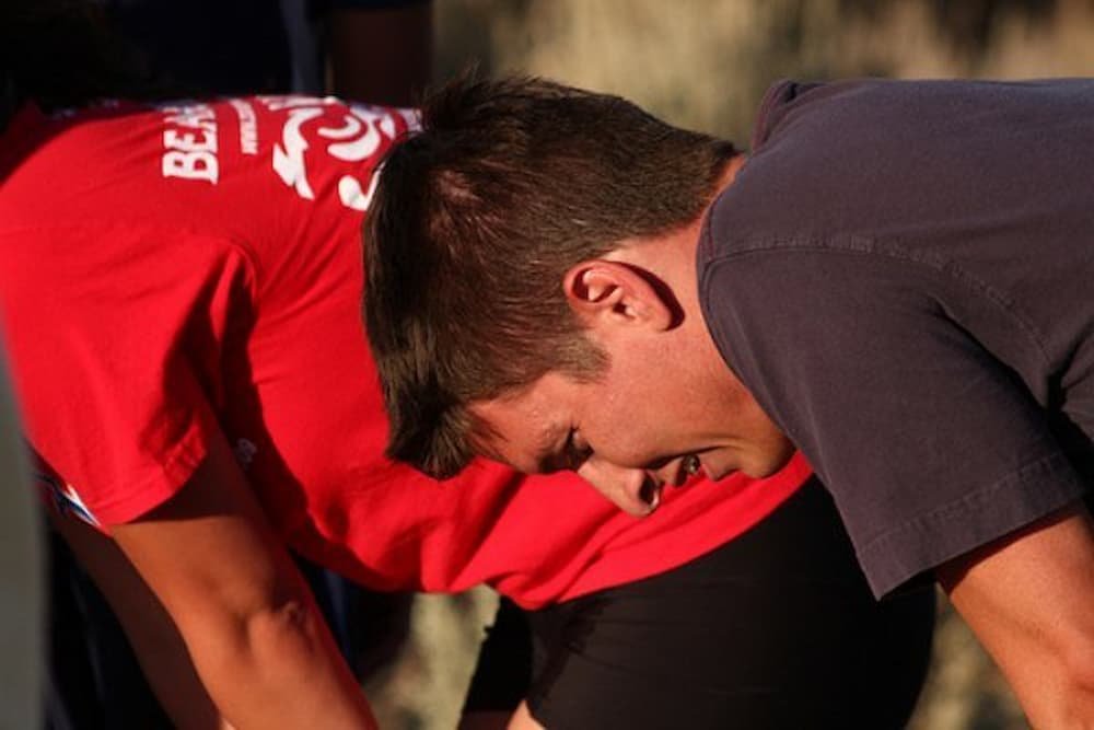 Man hunched over looking tired