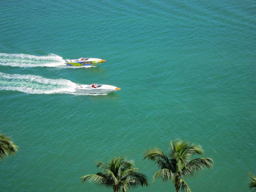 Two small powerboats driving alongside each other